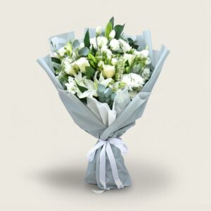 White condolence bouquet with mixed blooms and grey wrapping