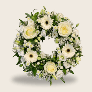 White condolence wreath with roses and gerberas