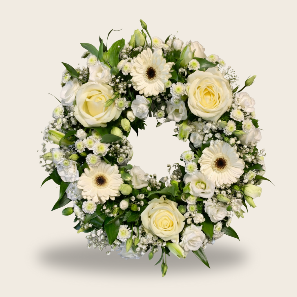 White condolence wreath with roses and gerberas