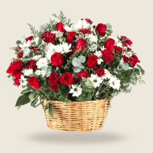 Basket arrangement of red roses, white daisies, and lush greens for special occasions