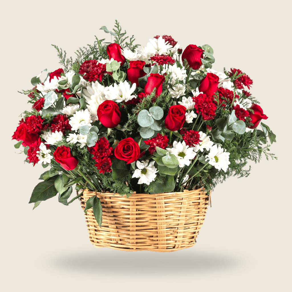 Basket arrangement of red roses, white daisies, and lush greens for special occasions