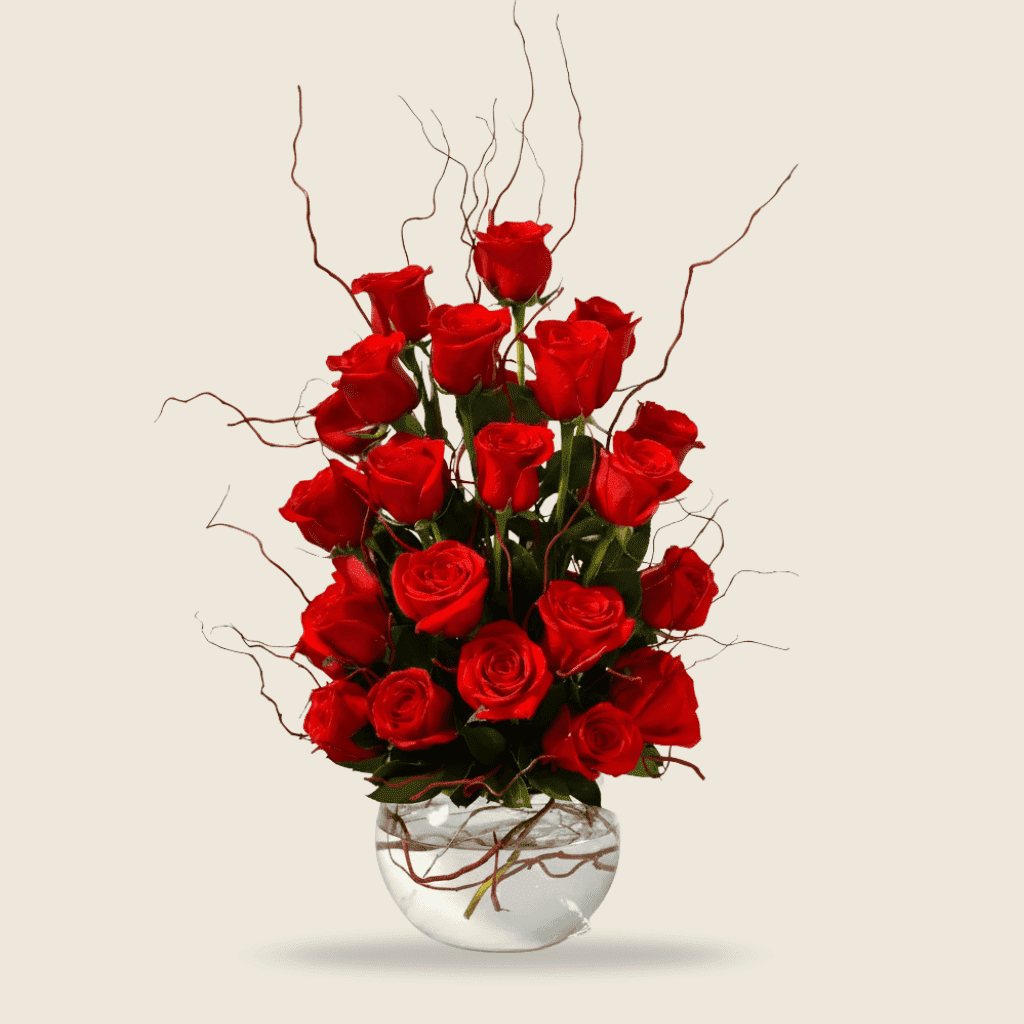 Modern round vase with upright red roses and twigs
