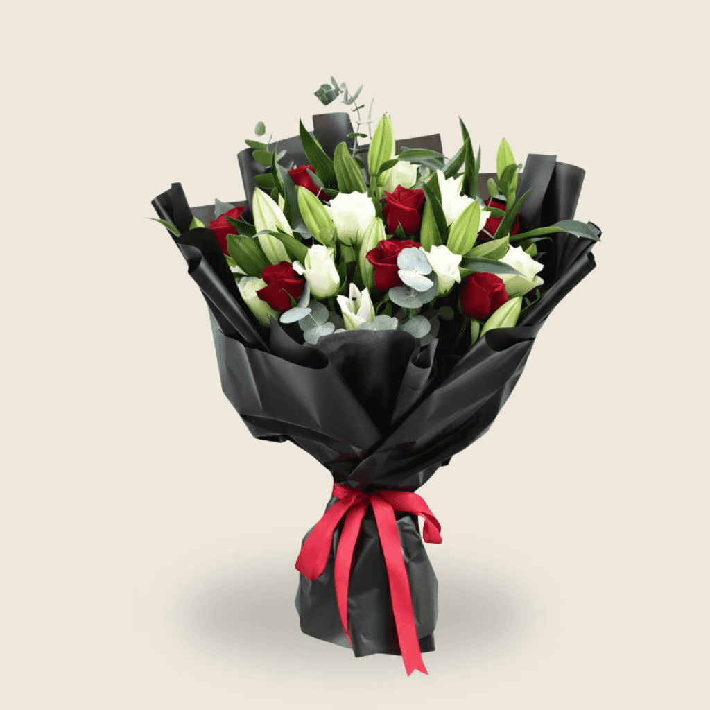 Luxurious bouquet of red roses and white lilies wrapped in black paper