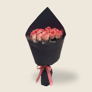 Chic bouquet of soft pink roses in black wrapping