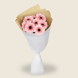 Soft pink gerbera bouquet wrapped in white and brown paper