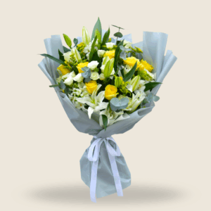 Large bouquet of white lilies, yellow roses, and greenery wrapped in grey paper