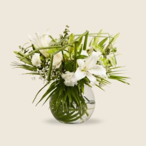 Elegant round arrangement of white lilies, roses, and carnations with lush greens