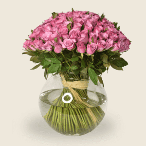 Fishbowl arrangement of purple roses with natural raffia