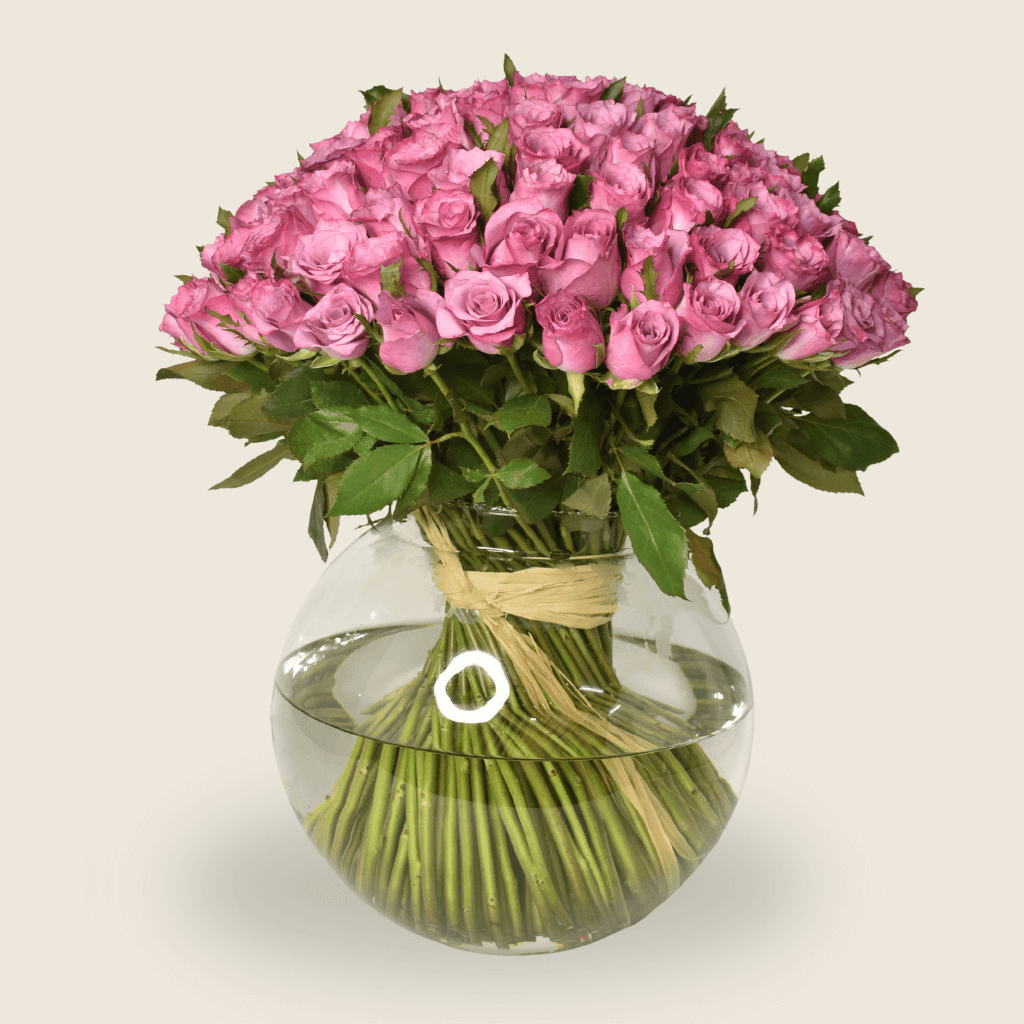 Fishbowl arrangement of purple roses with natural raffia